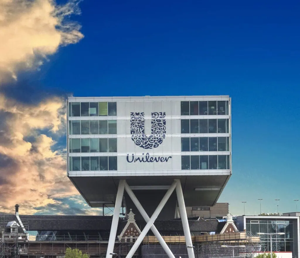 Modern Unilever office building with unique elevated design, showcasing innovative architecture and corporate branding, representing leadership in brand growth and business excellence.
